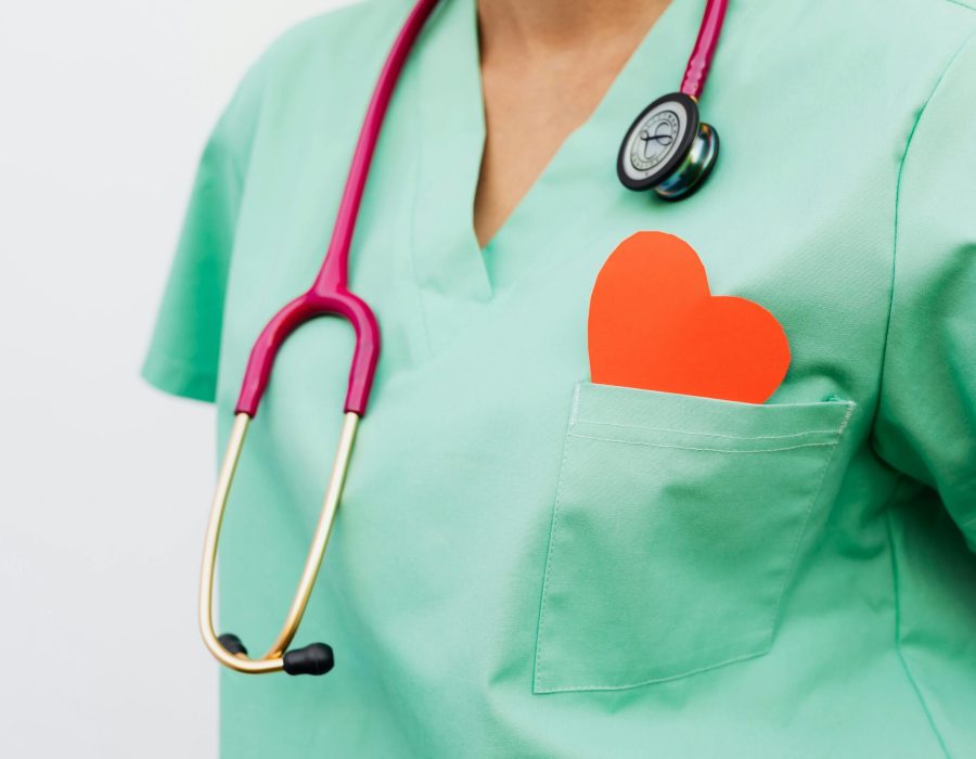A healthcare professional with a stethoscope and red heart symbol emphasizes cardiology care.